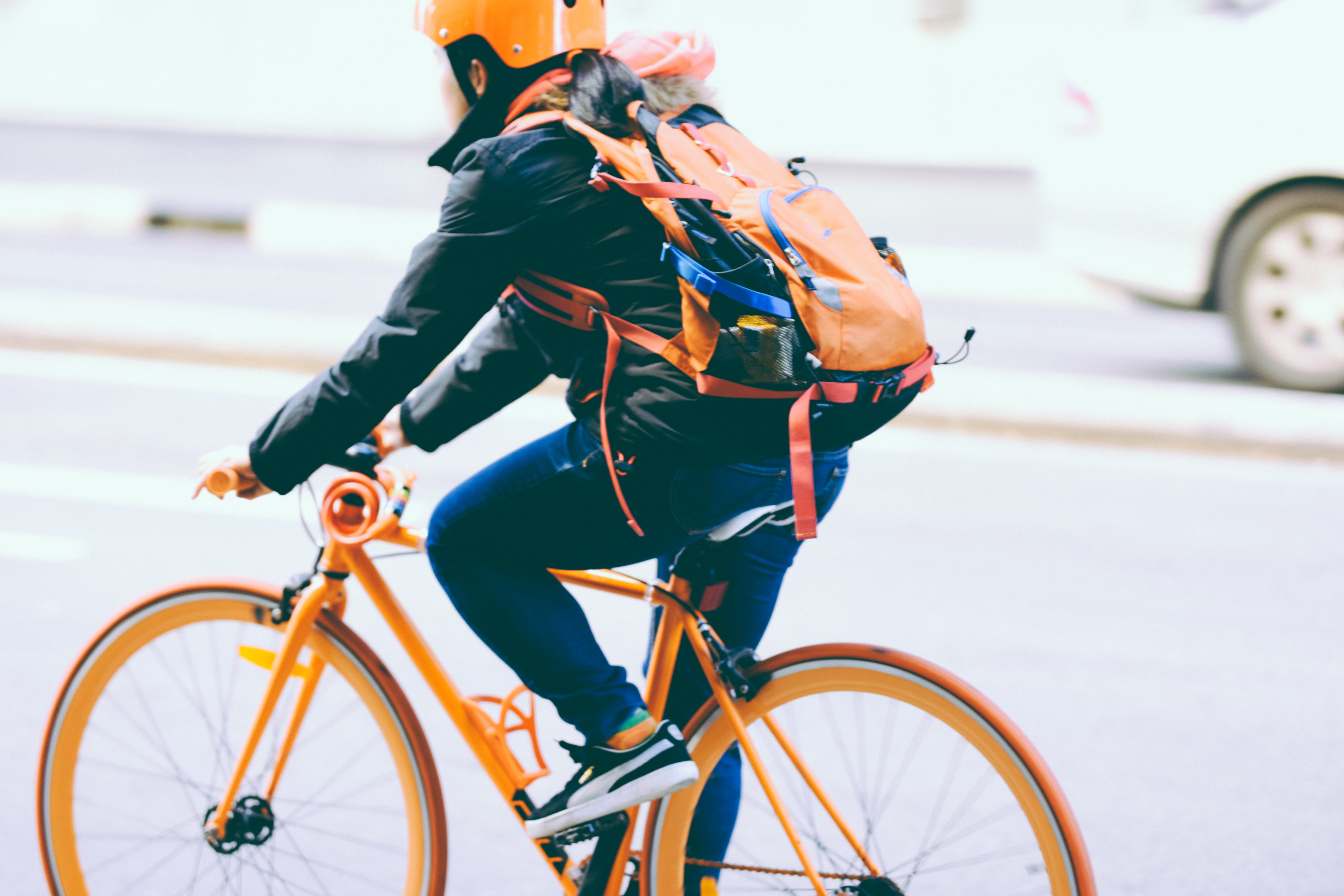 Woman wearing helmet bikes to work