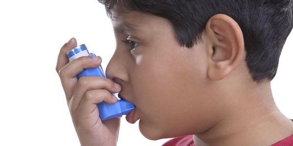 Boy using inhaler