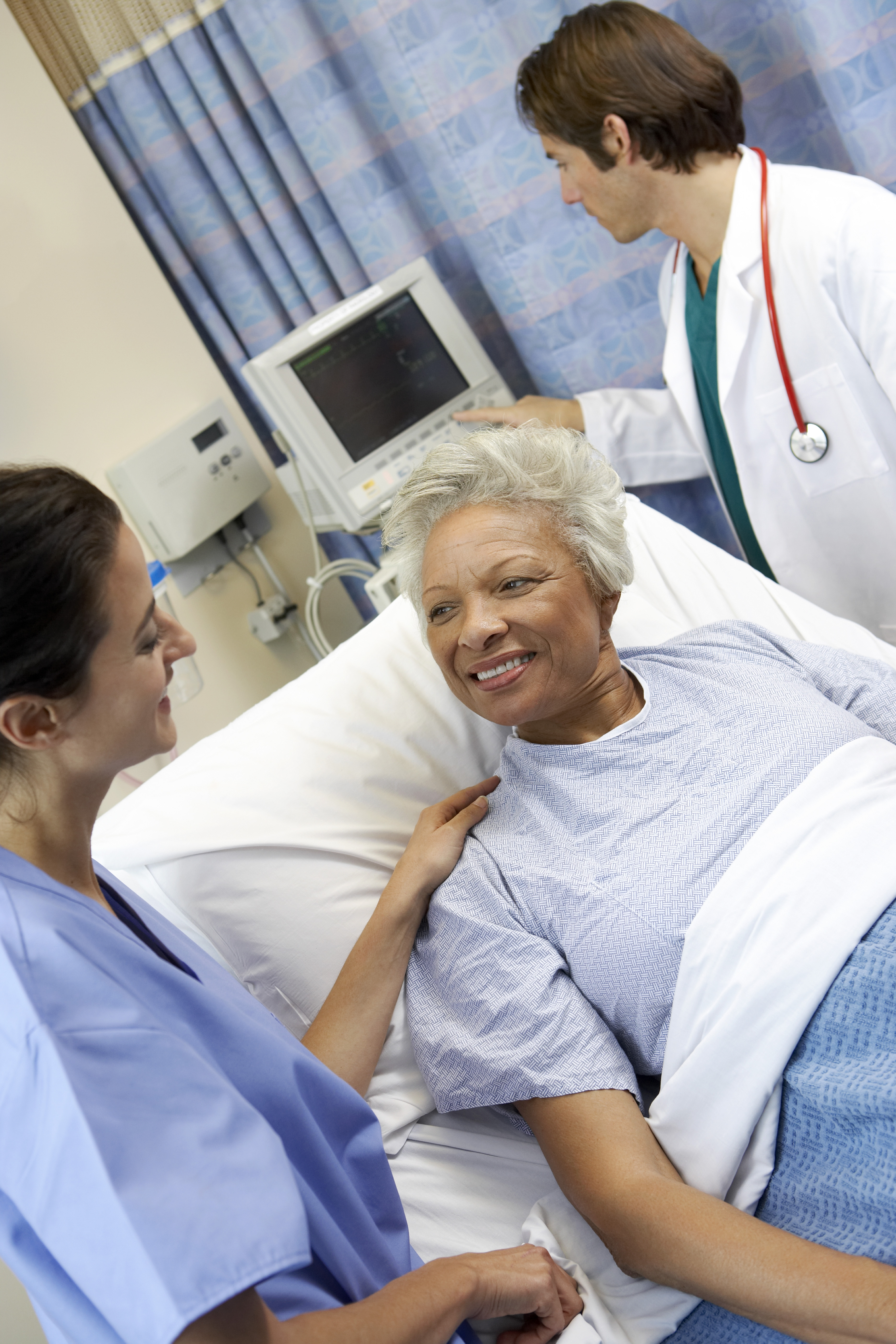 Picture of a medial professional with an elderly patient in a hospital bed